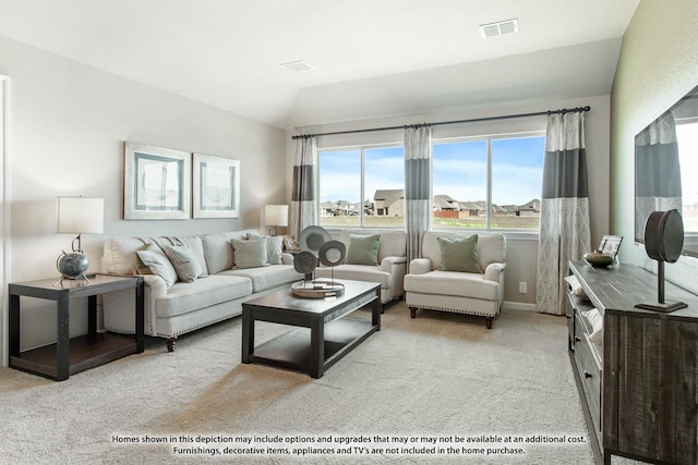 carpeted living room with lofted ceiling