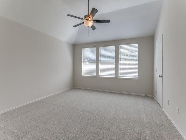 carpeted spare room with vaulted ceiling and ceiling fan