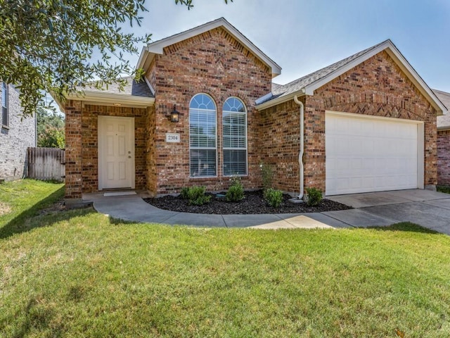 view of front of property featuring a garage and a front lawn