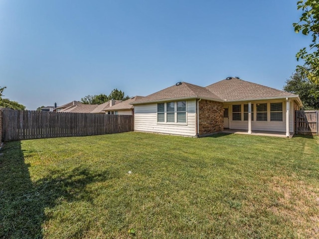 back of house featuring a yard and a patio