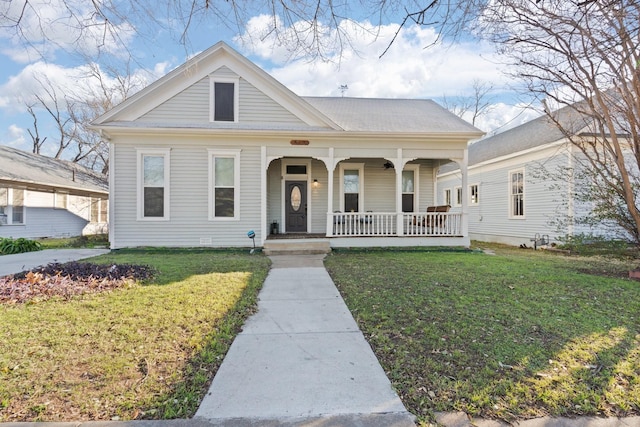 view of front of home featuring a front yard and covered porch