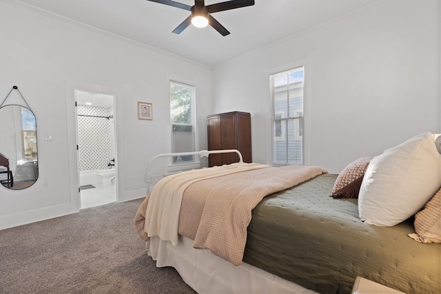 carpeted bedroom with multiple windows, ensuite bathroom, and ceiling fan