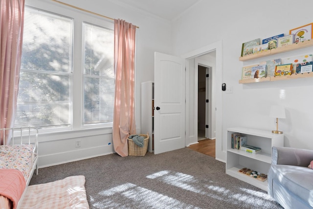 sitting room with dark carpet and plenty of natural light