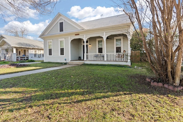 view of front facade with covered porch and a front yard