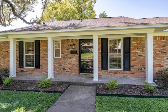 view of exterior entry with a porch