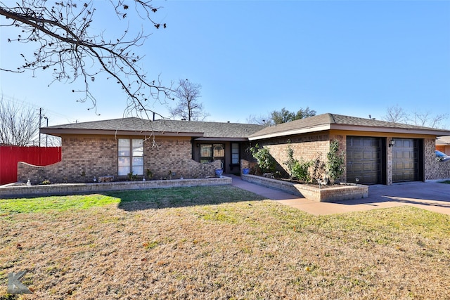 ranch-style home featuring a garage and a front yard