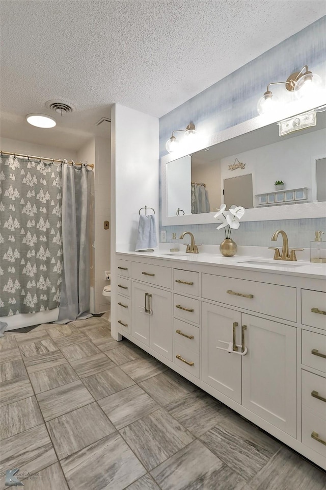 bathroom with vanity, a shower with shower curtain, a textured ceiling, and toilet