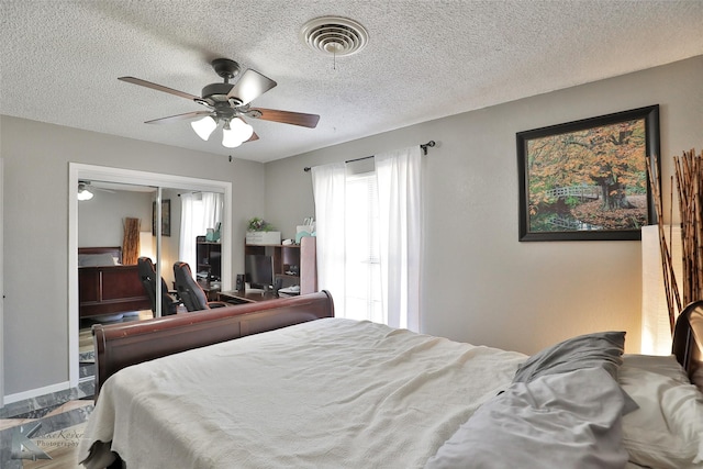 bedroom featuring a textured ceiling, a closet, and ceiling fan