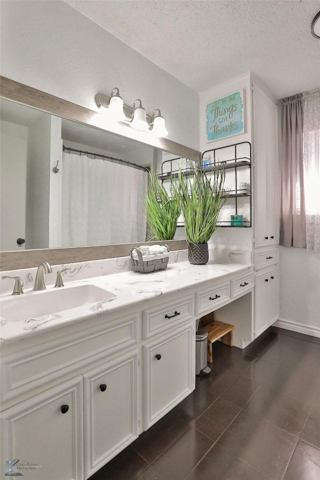 bathroom featuring vanity, a textured ceiling, tile patterned floors, and curtained shower