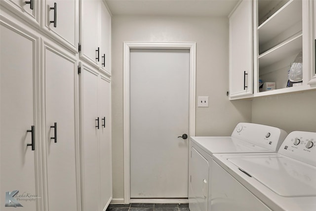 laundry area featuring washing machine and dryer and cabinets