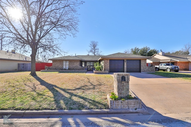 ranch-style house featuring a front yard and a garage