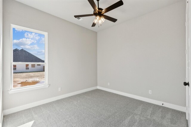 carpeted spare room with ceiling fan