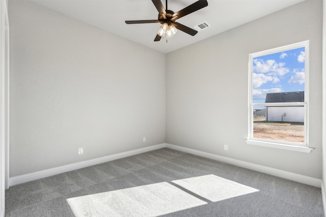 carpeted spare room with ceiling fan