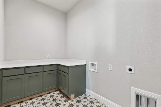 clothes washing area featuring electric dryer hookup, cabinets, and washer hookup