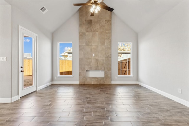 unfurnished living room featuring ceiling fan and vaulted ceiling