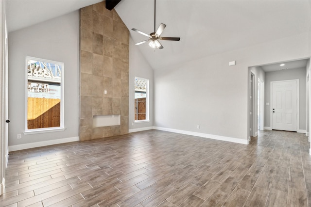 unfurnished living room with ceiling fan, beamed ceiling, and high vaulted ceiling