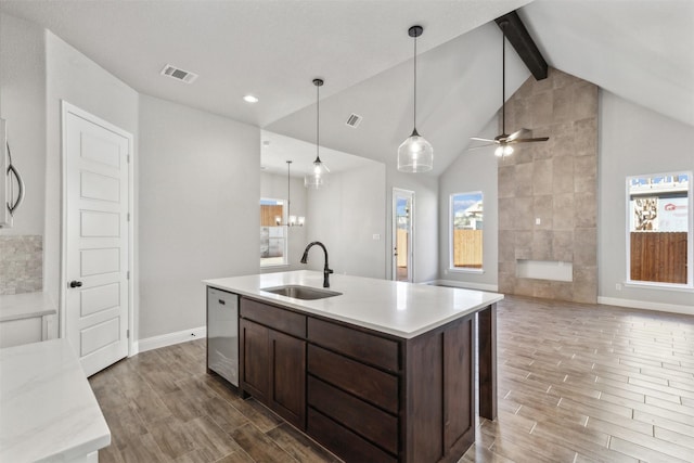 kitchen with a wealth of natural light, dishwasher, sink, and pendant lighting