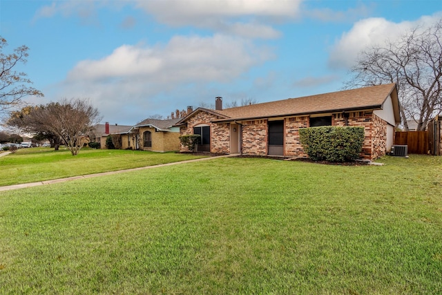 single story home featuring a front lawn and central AC unit