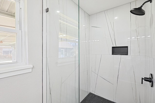 bathroom with tiled shower