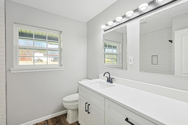 bathroom featuring hardwood / wood-style floors, toilet, walk in shower, and a wealth of natural light