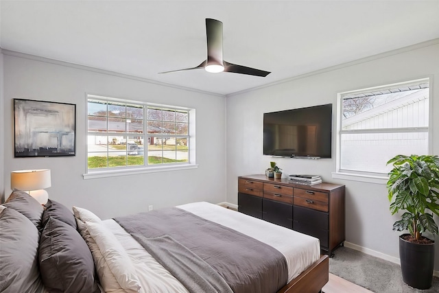 carpeted bedroom with ceiling fan and ornamental molding