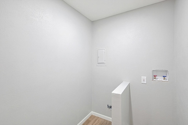 clothes washing area with washer hookup, hookup for an electric dryer, and wood-type flooring