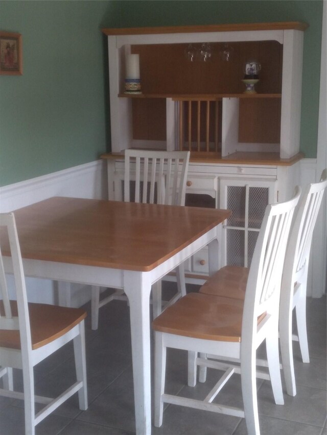 unfurnished dining area featuring tile patterned floors