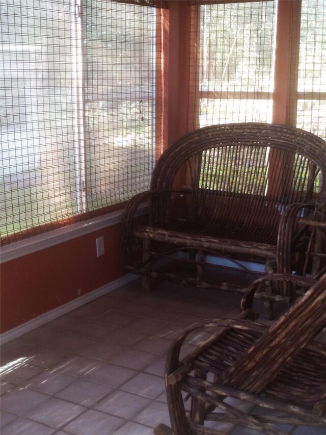 living area with tile patterned flooring and a healthy amount of sunlight