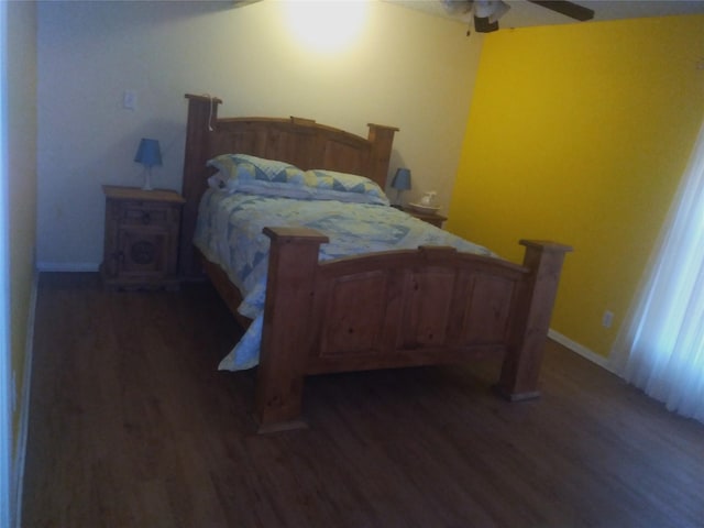 bedroom with ceiling fan and dark hardwood / wood-style floors