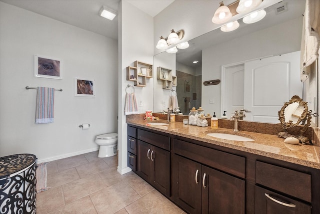 bathroom with tile patterned flooring, vanity, toilet, and an enclosed shower