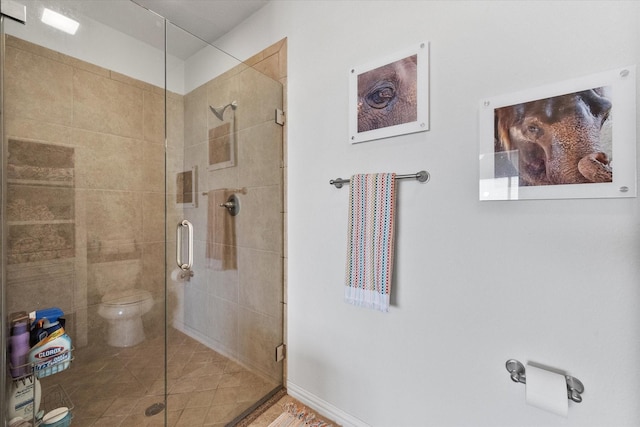 bathroom featuring toilet and walk in shower