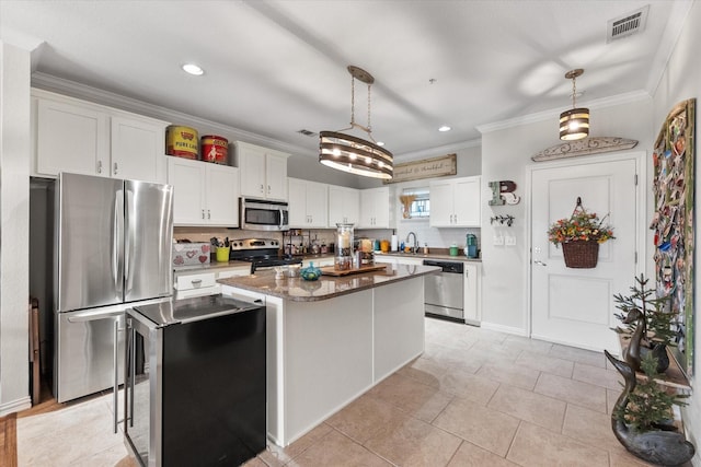 kitchen featuring white cabinetry, a center island, pendant lighting, and stainless steel appliances