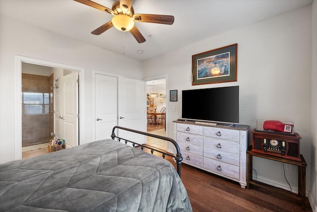 bedroom featuring ceiling fan, dark wood-type flooring, and ensuite bathroom