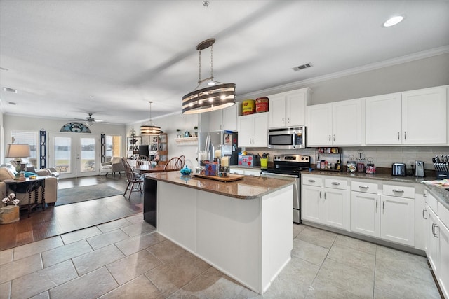 kitchen with white cabinetry, a center island, ceiling fan, stainless steel appliances, and pendant lighting