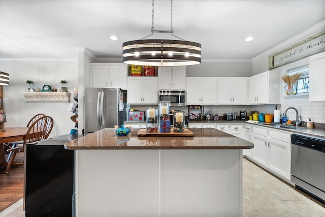 kitchen with appliances with stainless steel finishes, a center island, and white cabinetry