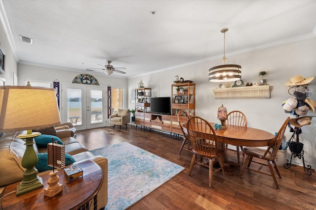 living room with ceiling fan with notable chandelier, french doors, dark hardwood / wood-style flooring, and ornamental molding