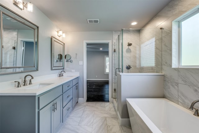 full bathroom featuring a sink, a garden tub, and a stall shower