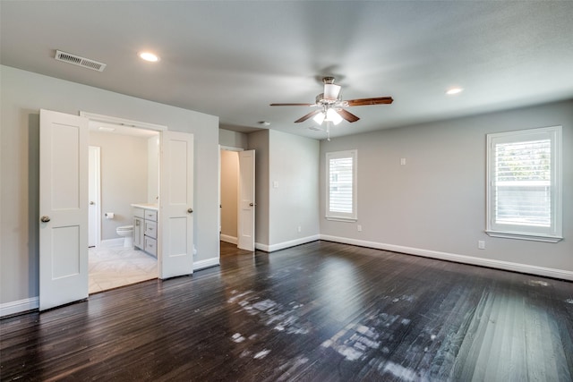 unfurnished room featuring visible vents, baseboards, a ceiling fan, and dark wood-style flooring