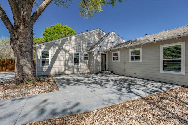 view of front of home featuring a patio area and fence