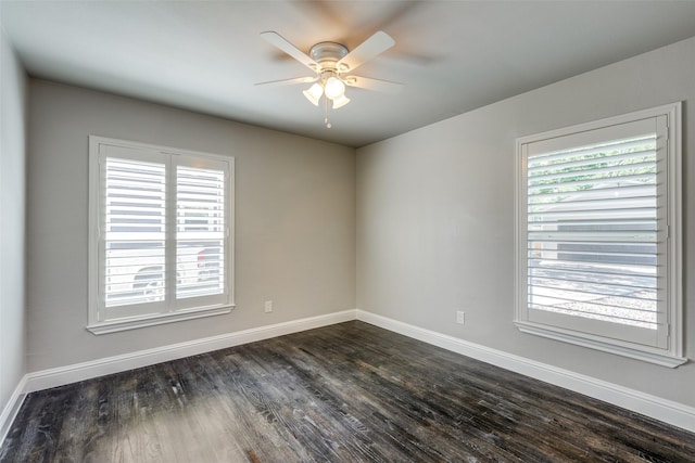 unfurnished room featuring dark wood-style floors, baseboards, and a ceiling fan