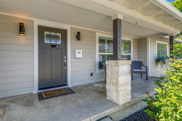 property entrance with covered porch