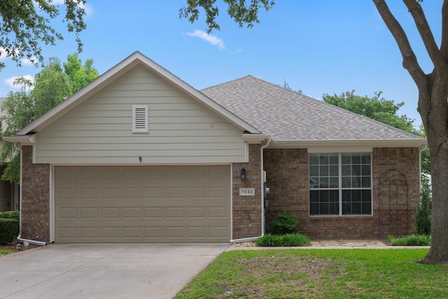 single story home featuring a garage and a front lawn