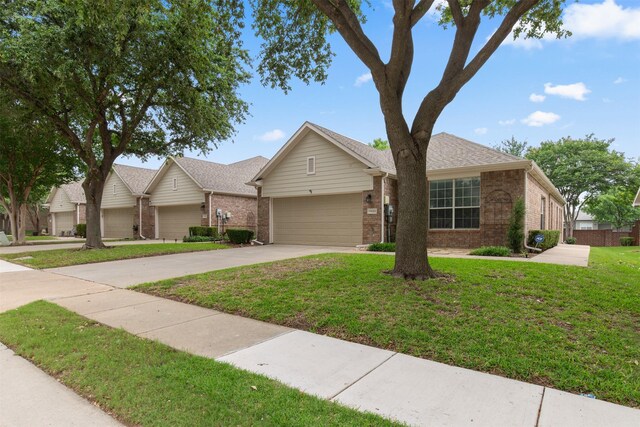 ranch-style home with a garage and a front lawn