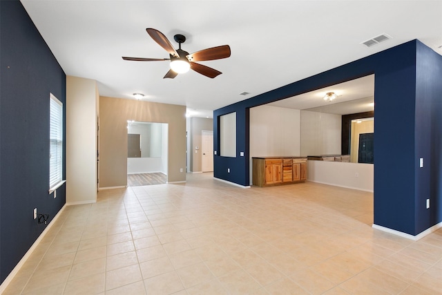 unfurnished living room with light tile patterned floors and ceiling fan