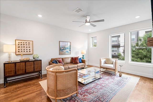 living room with hardwood / wood-style flooring, plenty of natural light, and ceiling fan