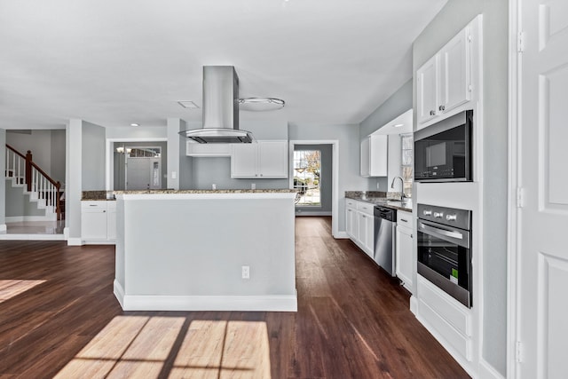 kitchen with island exhaust hood, dark wood-type flooring, white cabinets, and stainless steel appliances