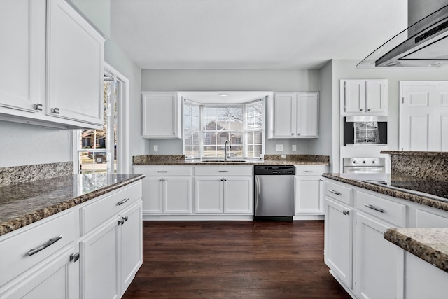 kitchen featuring dishwasher, sink, dark hardwood / wood-style flooring, dark stone counters, and white cabinets