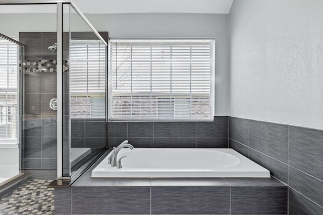 bathroom with shower with separate bathtub