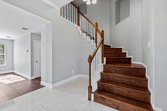 stairs featuring crown molding