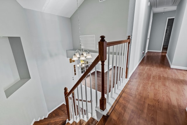 hall featuring a notable chandelier and wood-type flooring